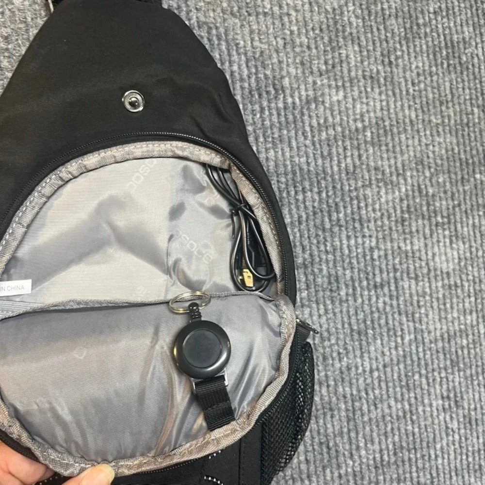 Black Sling Backpack Crossbody Shoulder Bag with Bungee Cord and Headphone Port